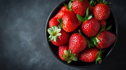 Fresh red strawberries in black ceramic bowl with dark background food photography studio lighting setup concept