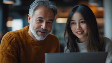 An elderly couple looking at a laptop screen. Useful for articles about technology and learning.