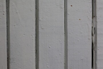 Textured white wooden wall with natural wear and tear details showcasing a rustic background element