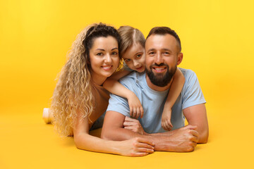 Portrait of happy family on yellow background