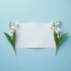 Minimalist snowdrop floral frame with a blank white card on a soft blue backdrop