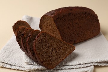 Pieces of fresh rye bread on beige background, closeup