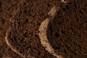 Pieces of fresh rye bread as background, closeup