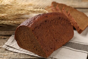 Pieces of fresh rye bread on wooden table, closeup