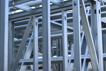 Light steel thin-walled structures. Frames for warehouses, garages and houses. Steel frame construction for construction. Details. Light steel frame fragment close-up. Construction concept