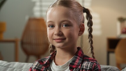 Close up portrait face of little Caucasian preteen girl daughter happy carefree calm smiling child...