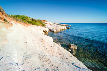 Rocky coast of Cyprus with rocks in the water, near the town of Peyia, Cyprus.