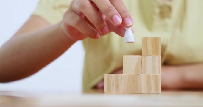 Explore how stacking wooden blocks fosters creativity and problem-solving skills in a home workspace.