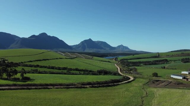 Aerial drone footage showcasing lush farmland at golden hour with sweeping views of the iconic Sleeping Beauty mountain in Riversdale, Eastern Cape, South Africa. 