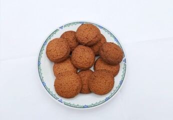Oatmeal cookies on a white plate.