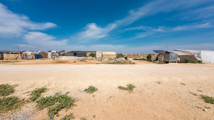 Makeshift Settlement Under Blue Sky
