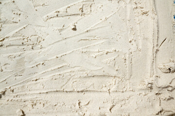 Closeup view of sand with abstract texture. Beach scene. Summer concept. Top view