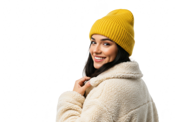 A smiling woman in a winter hat and coat looks back, isolated on transparent background