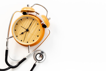 Stethoscope and vintage alarm clock, top view. Time for medical checkup