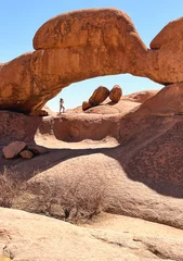 Man under a red arch in Spitzkoppe, Namibia © Nicole