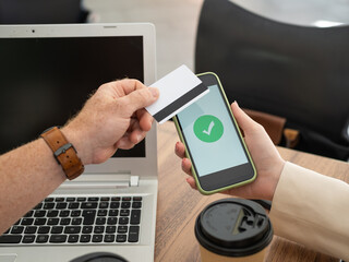 Business people making secure online payment with credit card and smartphone