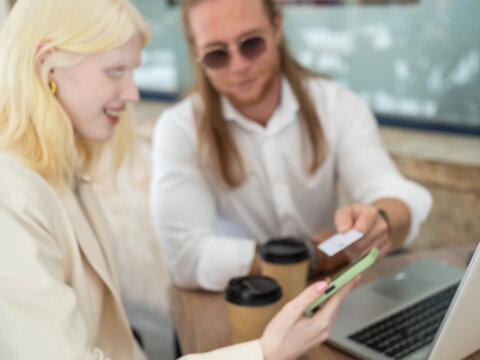 Business professionals collaborating over coffee and technology