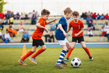 Kids Playing Soccer Match on Green Field – Youth Football Game with Boys in Action in Sports Uniforms