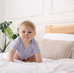 Cute little baby on bed at home