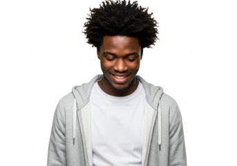 A happy black man wearing a hoodie and tshirt smiles joyfully while looking down, isolated on a transparent background