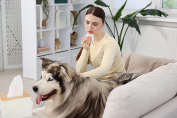 Woman suffering from allergy with her dog at home