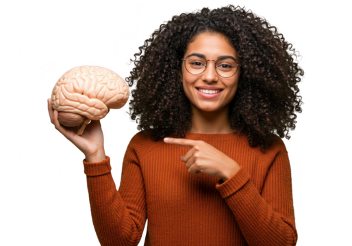 A young woman with curly hair and glasses holds a human brain and points to it, smiling, isolated on transparent background