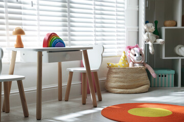 Stylish playroom with toys and furniture. Interior design