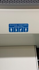 Malaga, Spain - March 30, 2025: Malaga Metro, Guadalmedina Station. Reserved seats sign in public...