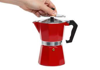 A hand places the lid on a red moka pot coffee maker isolated on a transparent background