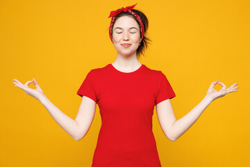Young woman she wearing red t-shirt casual clothes hold spreading hands in yoga om aum gesture...