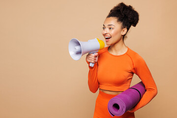 Young strong fitness trainer instructor sporty woman wear orange clothes spend time in gym scream...