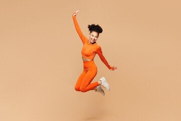 Full body young winner fitness trainer instructor sporty woman sportsman wear orange clothes spend...