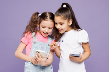Little smiling fun two friends kids children girls 9-10 years old wear casual clothes together hold...