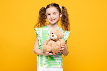 Little smiling adorable cheery fun cute kid child girl 8-9 years old wears green t-shirt hold hug...