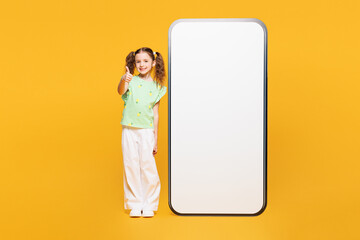 Full body little kid child girl 8-9 years old wears green t-shirt big huge blank screen mobile cell...