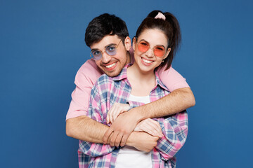 Young smiling happy couple two friends family man woman they wearing pink casual clothes sunglasses...