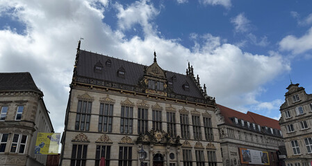 Fototapeta premium Bremen, Spain - May 04, 2025: The Bremen Town Musicians. Historic building with ornate architecture in Bremen, Germany under a cloudy blue sky with copy space