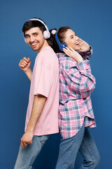 Young couple two friends family man woman wear pink casual clothes together listen music in...