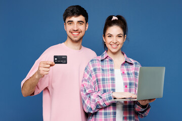 Young couple two friend family man woman they wear pink casual clothes together use laptop pc...