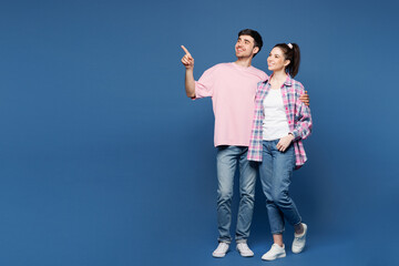 Full body young couple two friends family man woman wearing pink casual clothes together point...
