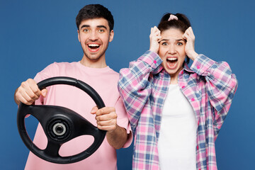 Young shocked scared couple two friends family man woman wearing pink casual clothes together hold...