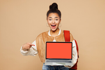 Young smart girl IT student wear casual clothes backpack bag hold use work point on blank screen...