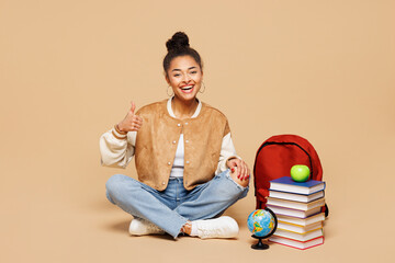 Full length young smiling fun smart girl student wear casual clothes backpack bag sit near books...