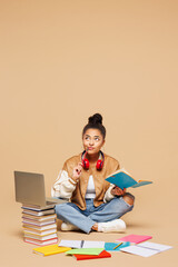 Full length young smart pensive girl student wear casual clothes backpack bag sit near books read...