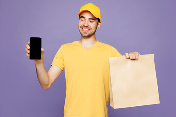 Delivery guy employee man wear yellow cap t-shirt uniform workwear work as dealer courier hold...