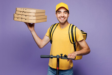 Young delivery guy employee man wears yellow cap t-shirt uniform workwear thermal bag work as...