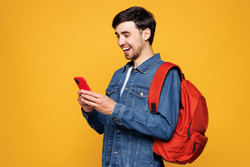 Young boy student he wearing jeans casual clothes backpack bag hold in hand mobile cell phone...