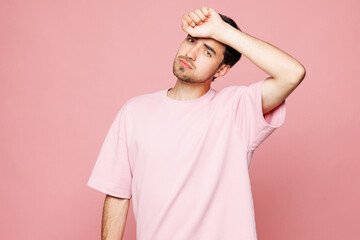 Young sad sick ill tired exhausted Caucasian man he wearing t-shirt casual clothes put hand on...