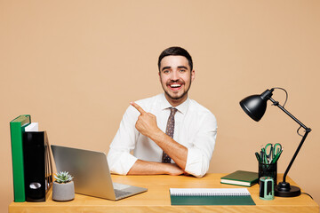 Young fun successful employee business man wear white shirt tie sit work at office desk with pc...