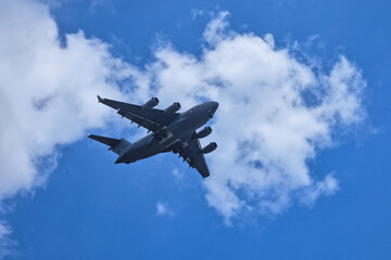 Large jet flying through blue sky.